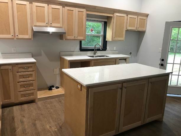 A kitchen with wooden cabinets

Description automatically generated