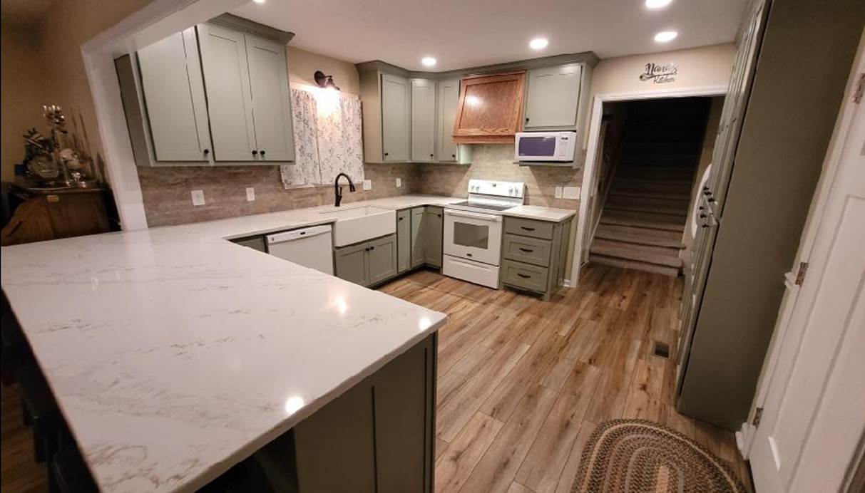 A kitchen with a marble counter top

Description automatically generated